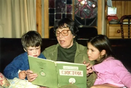 A woman reading to two children