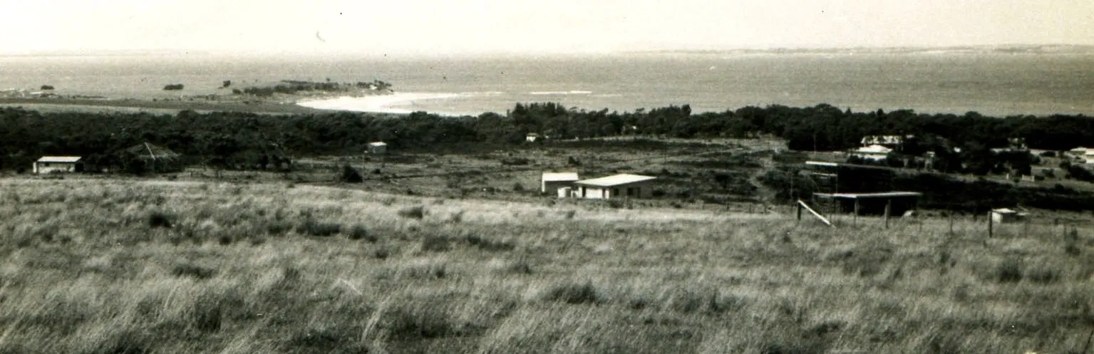 A black and white photo of an open field.