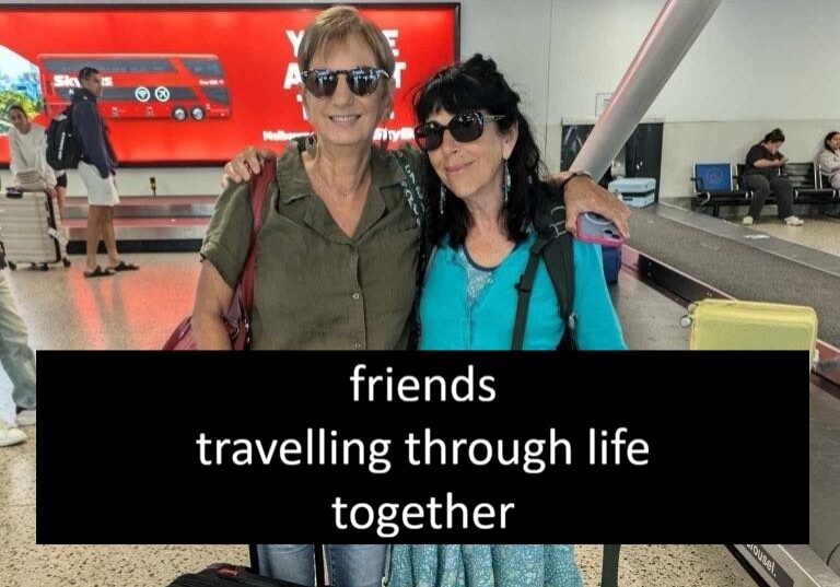 Two women with luggage at airport
