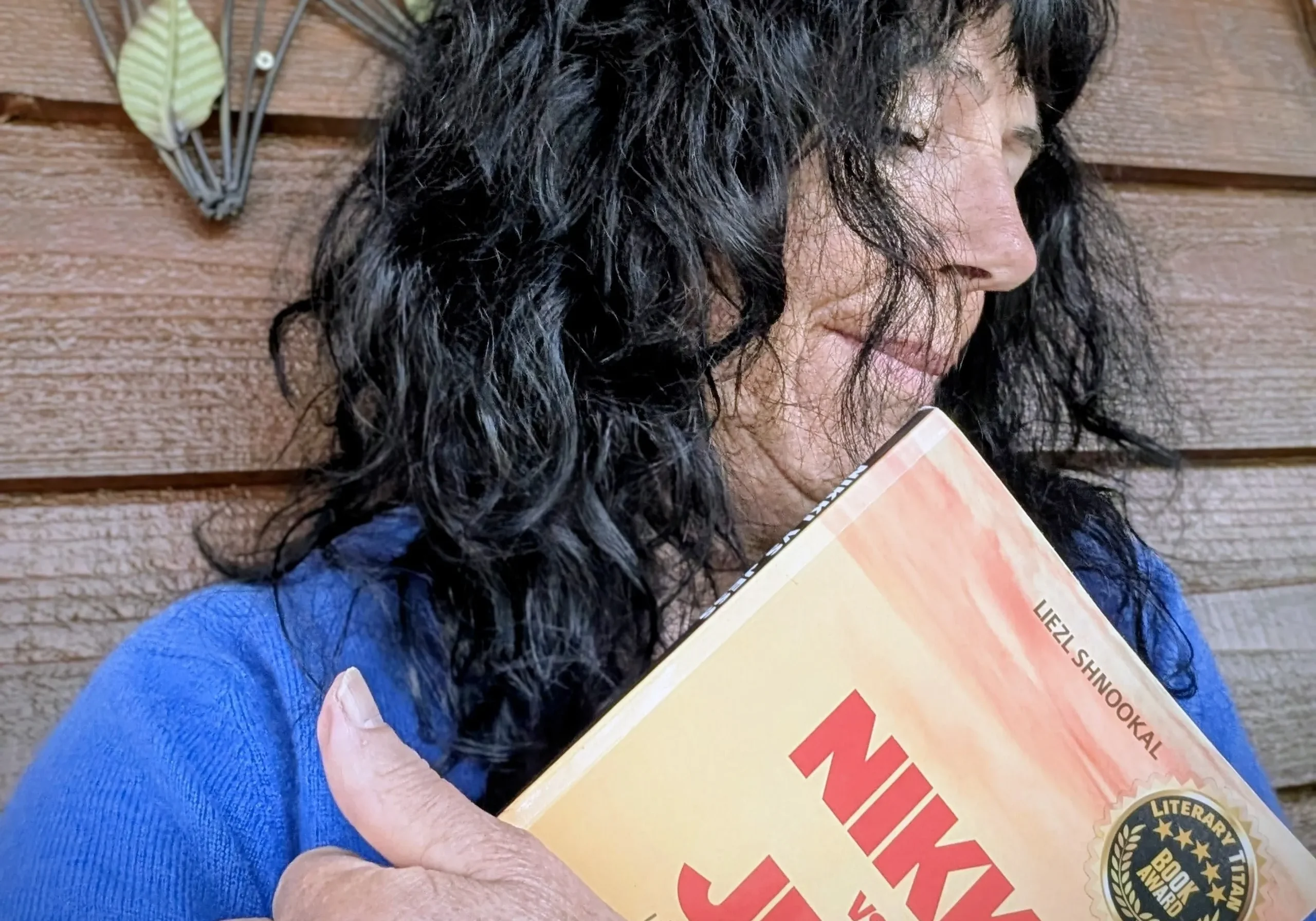 Person with black hair holding book