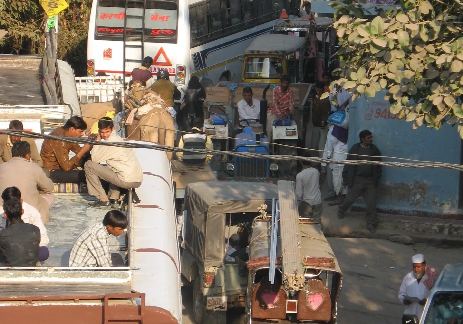 Busy Indian street with buses and rickshaws